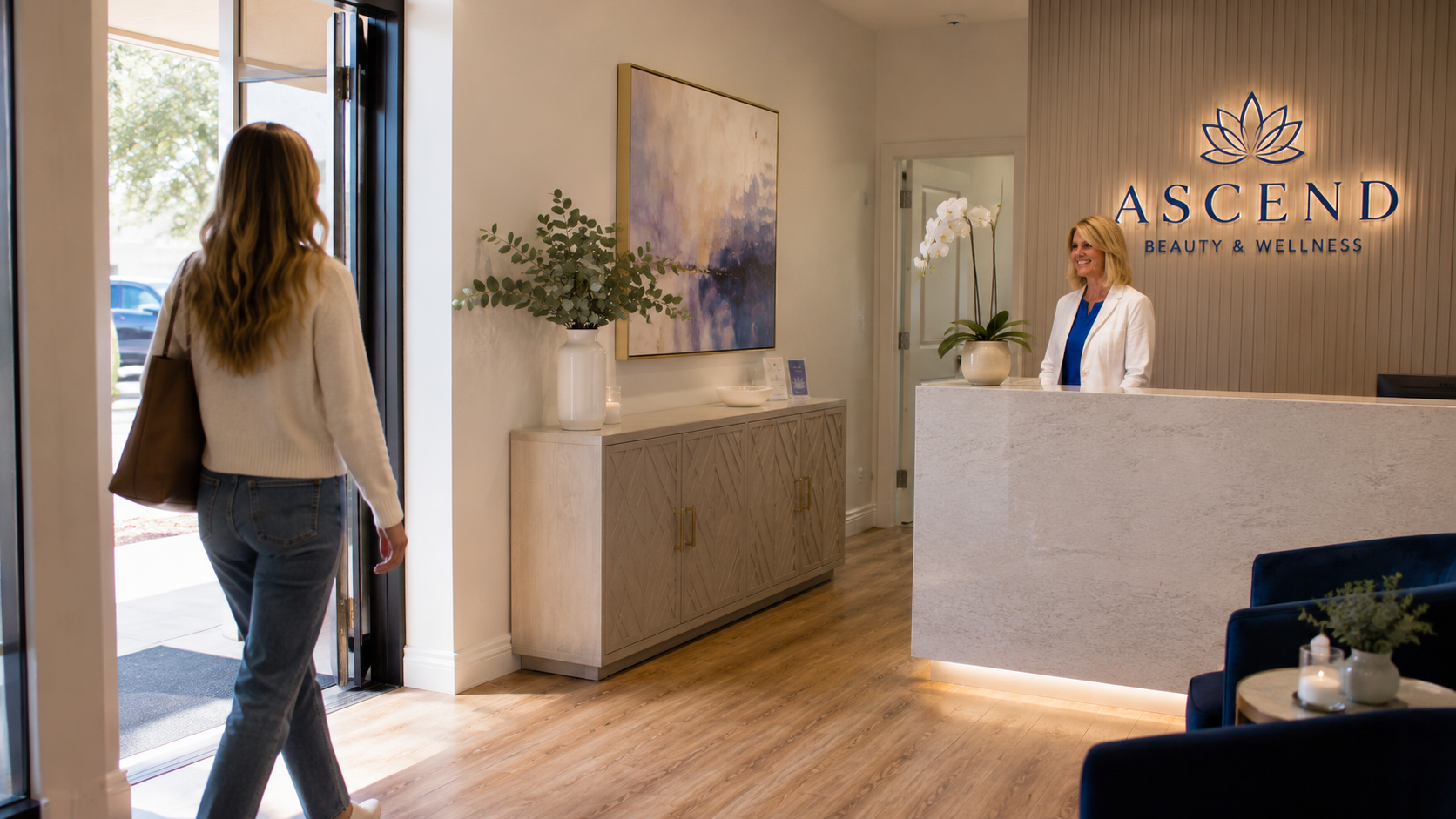 A patient walking into the Ascend Beauty & Wellness reception area, greeted at the front desk